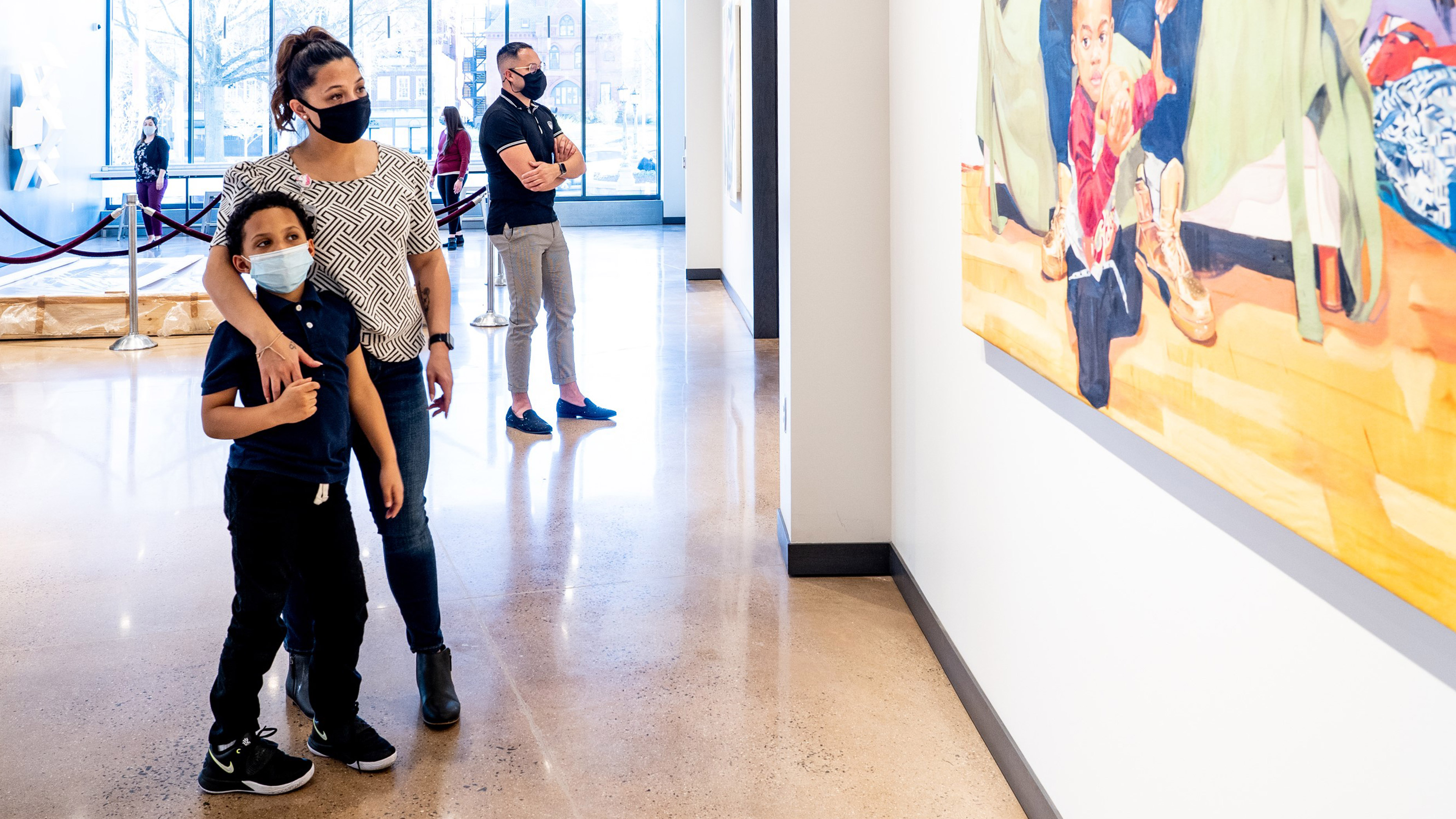 Patrons look at artwork in the new gallery spaces of Waterbury's Mattatuck Museum