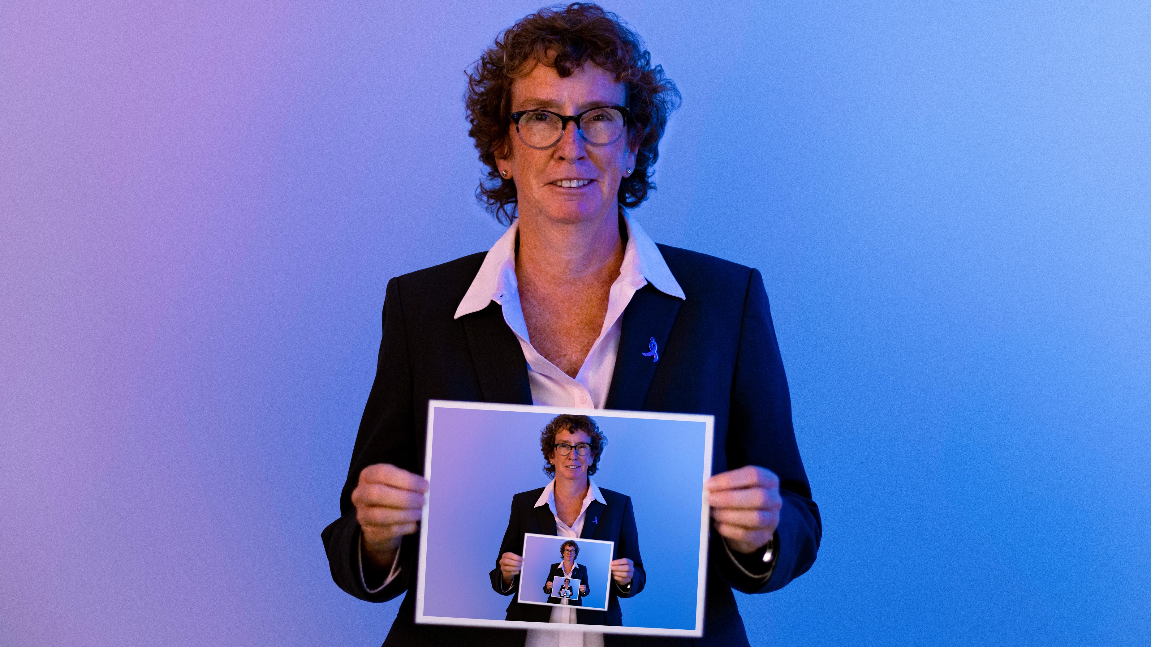 Cathy Awwad holding repeating images of herself, from photos taken in her Waterbury, Connecticut office
