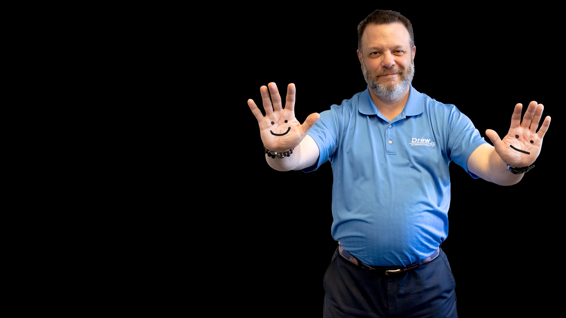 Frank Monteiro of Waterbury CT standing with hands out, smiling faces drawn on his palms