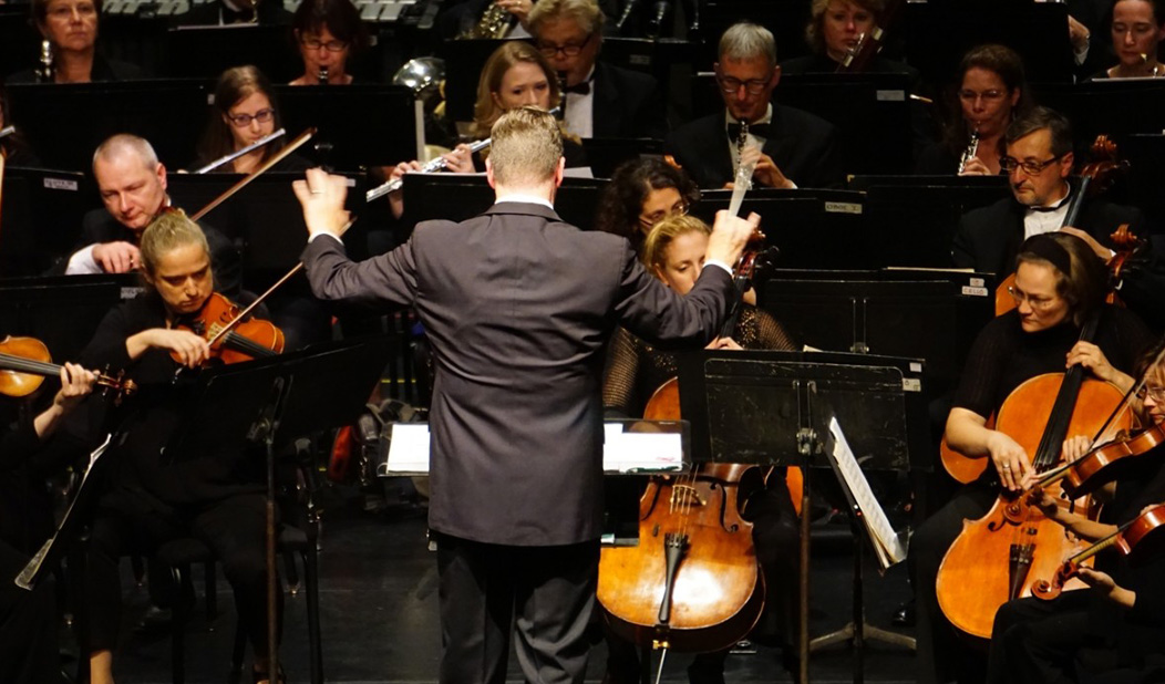 Musicians and conductor playing in the Waterbury Symphony Orchestra