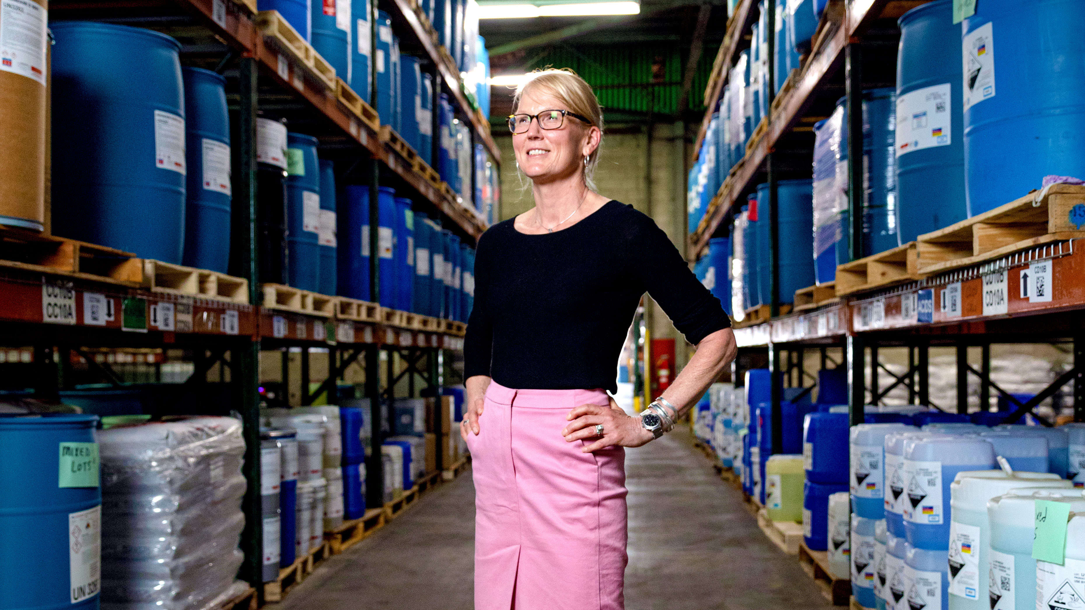 Molly Kellogg of Waterbury CT standing and smiling in Hubbard Hall manufacturing facility