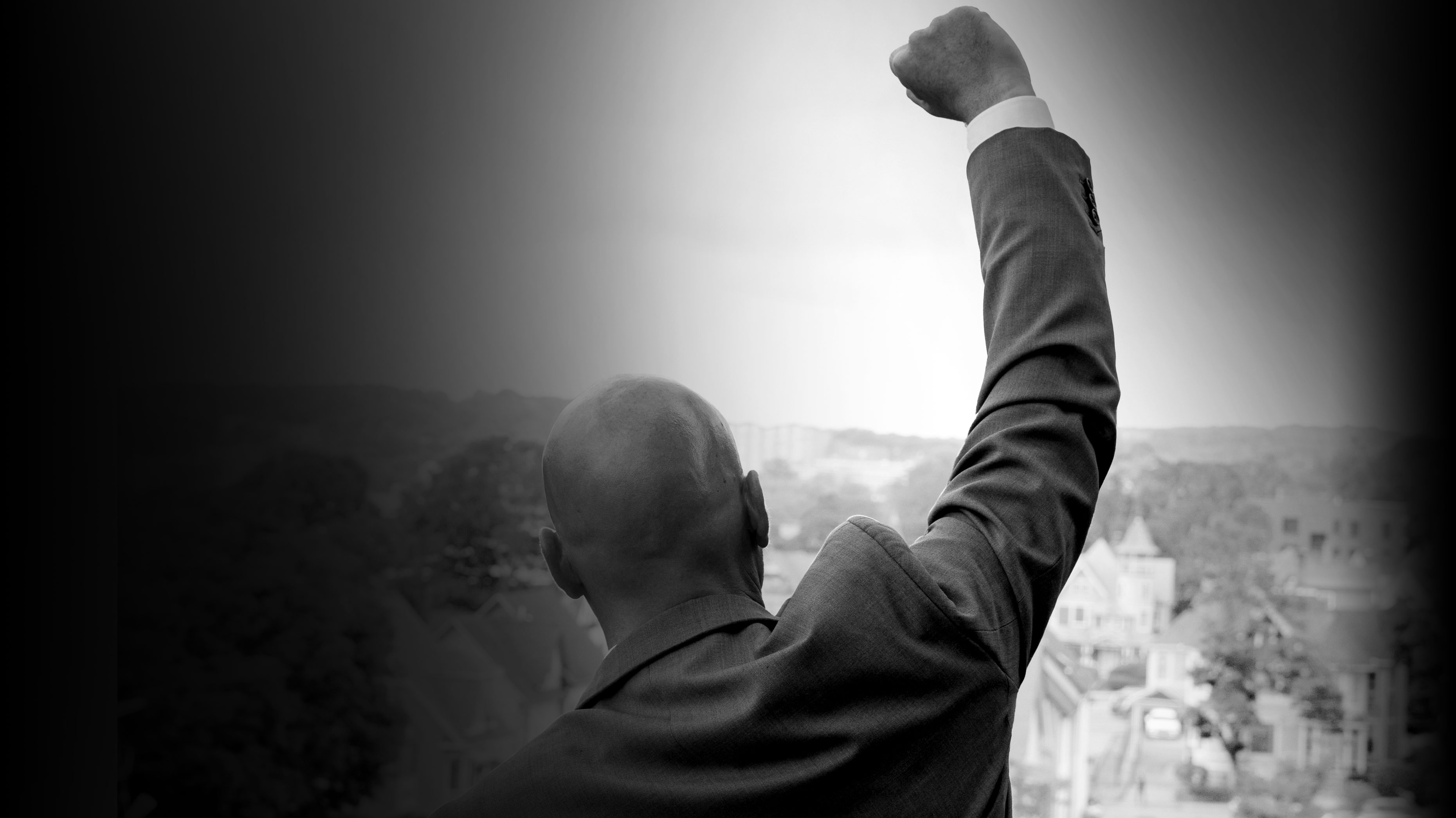 YMCA CEO Jim O'Rourke raises his arm while overlooking the City of Waterbury