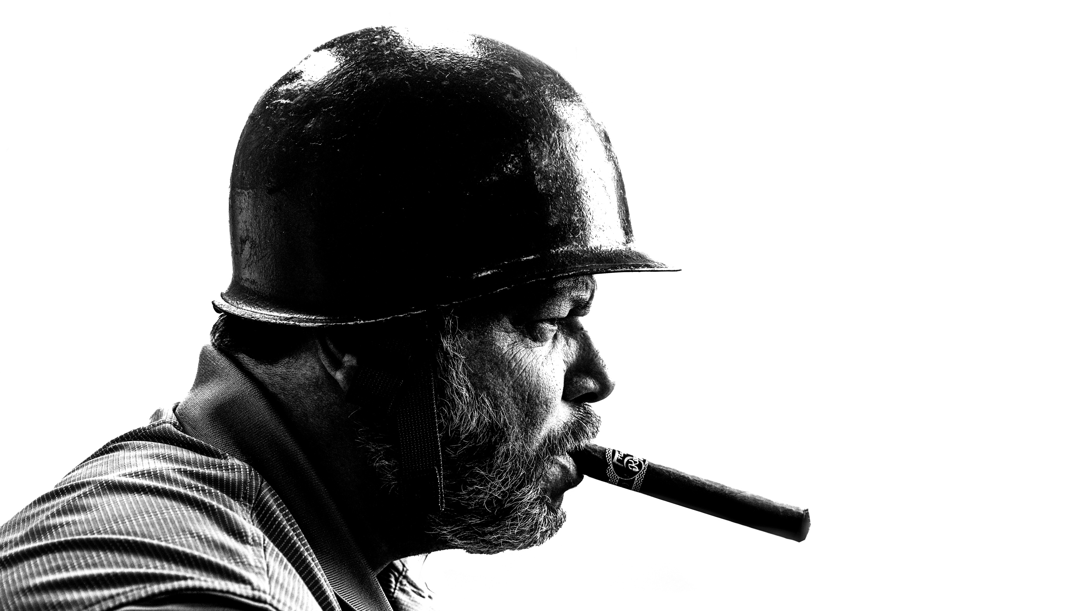 A black and white profile headshot of Frank Monteiro of Waterbury CT wearing an army helmet, cigar in mouth