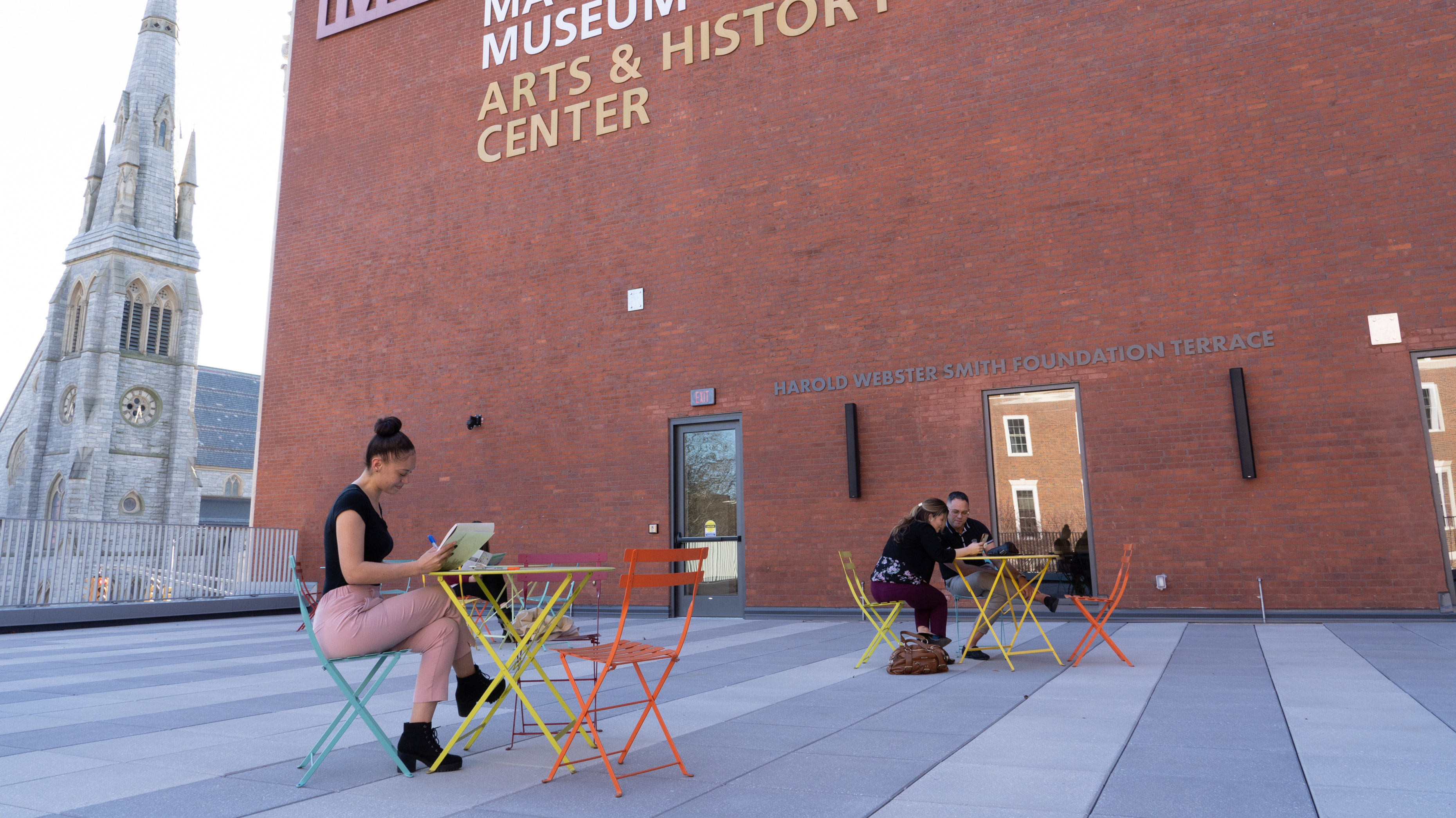 Patrons enjoying the outdoor terrace overlooking the Waterbury Green at the Mattatuck Museum