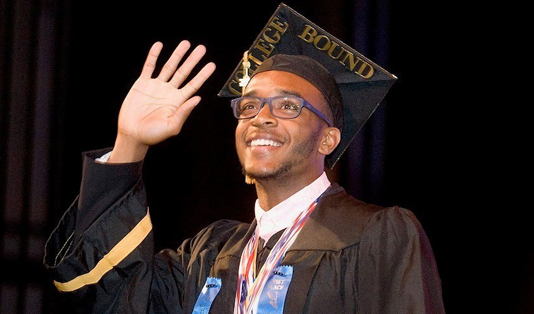 Male Waterbury CT high school student at graduation smiling and waving