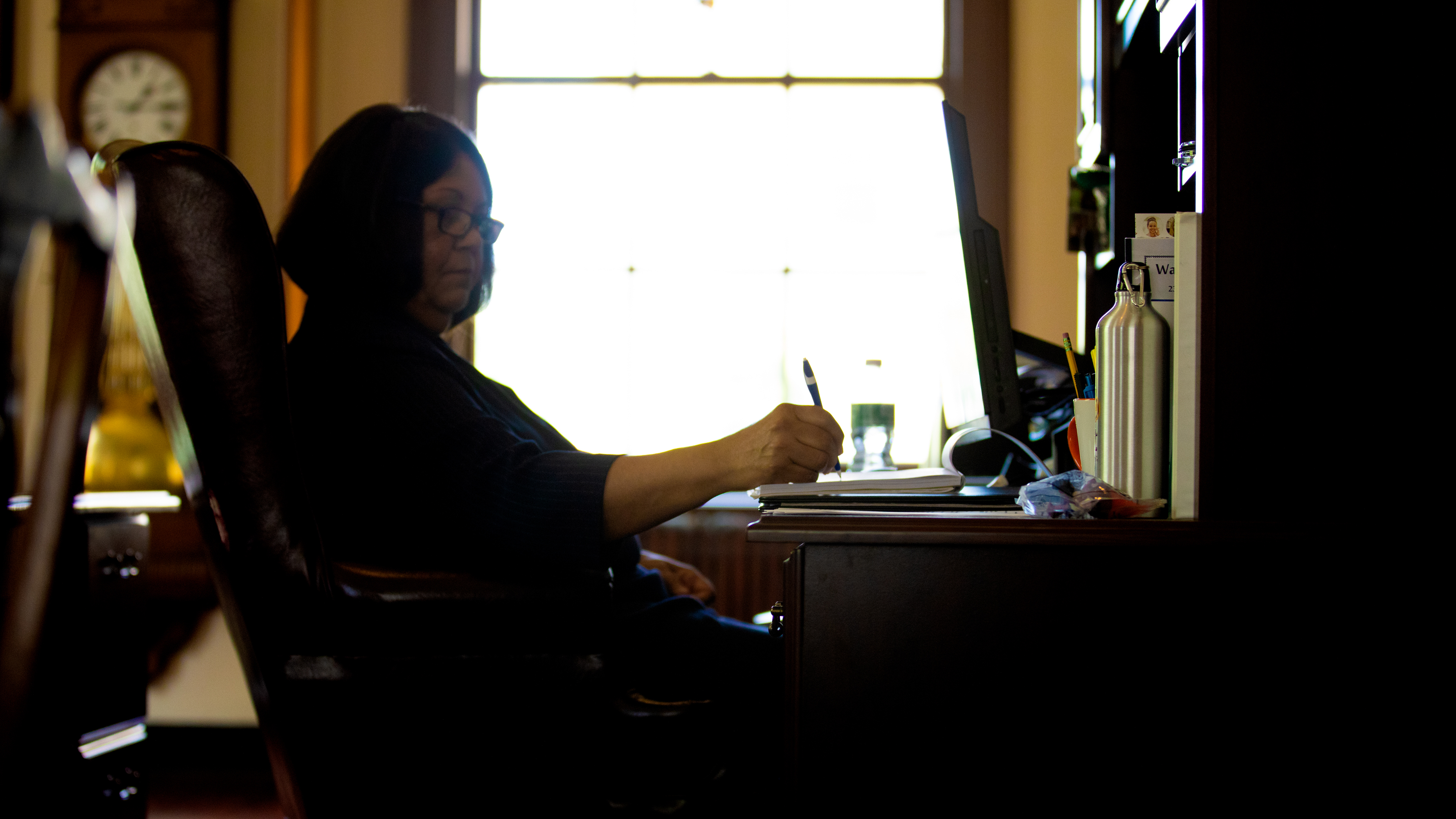 Waterbury Public Schools Superintendent Verna Ruffin sitting at her desk writing on paper