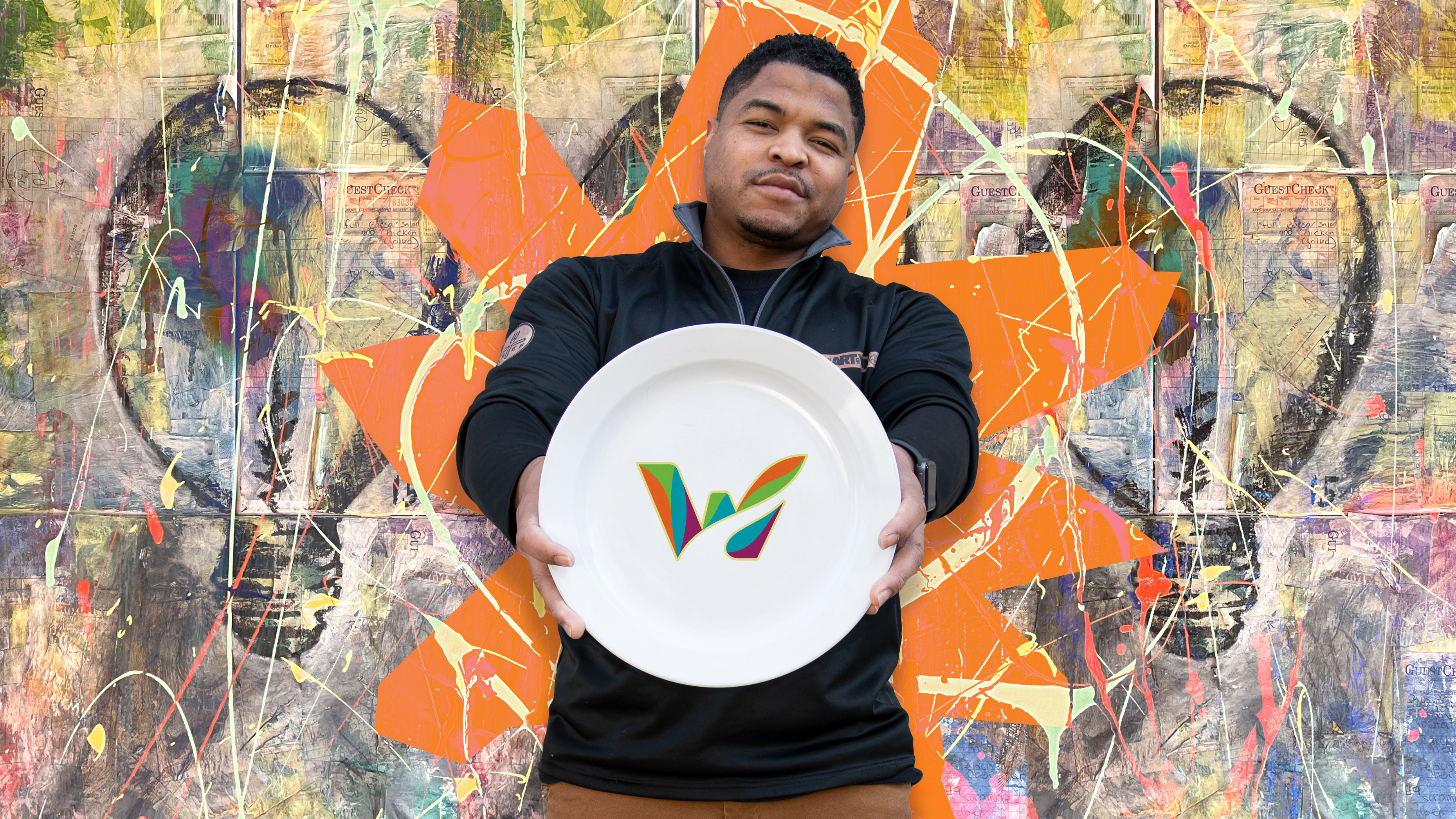 The Art Of Yum celebrity chef Michone Arrington holding a plate with the Waterbury logo on it