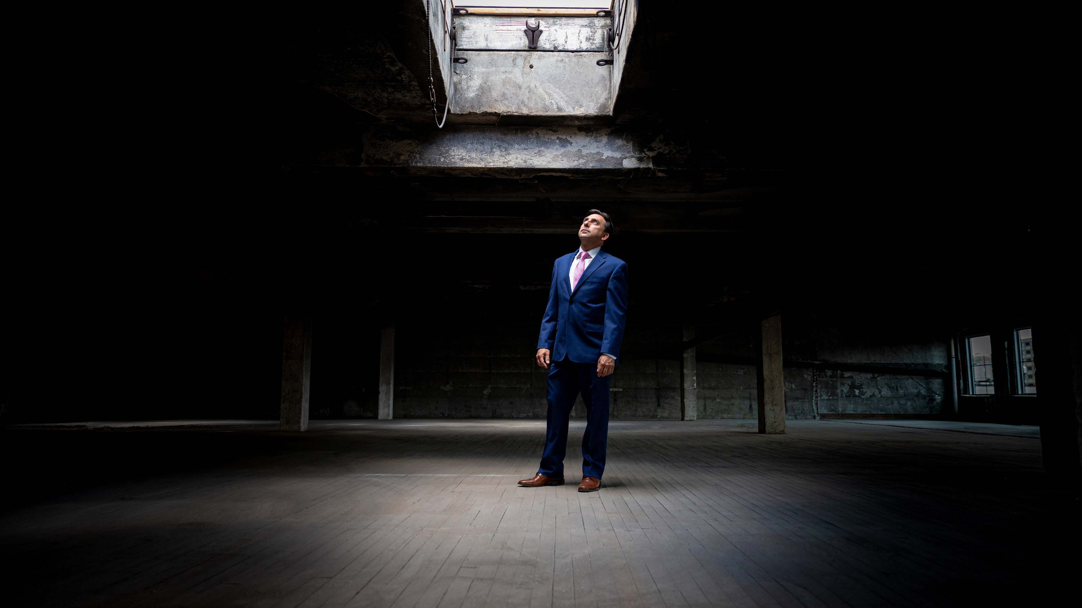 Joe Gramando of Waterbury CT standing under an open skylight in a dark building