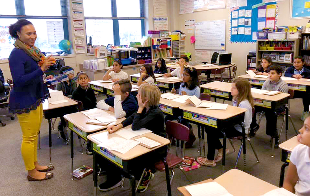 Waterbury CT public school classroom full of elementary school students sittiing at desks and learning