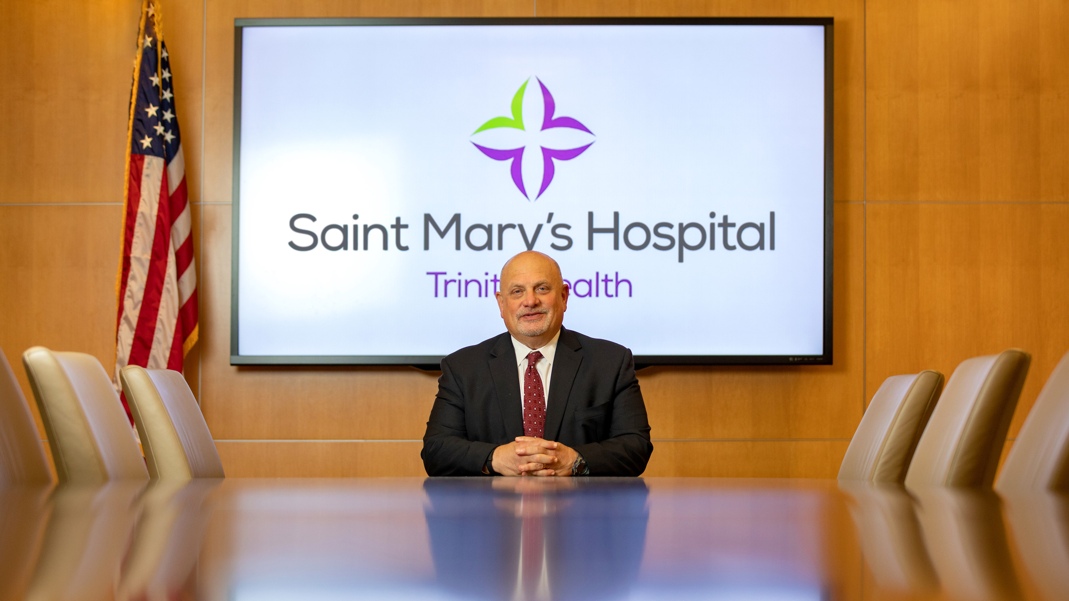 Dr. Steve Schneider sitting at a long table at Saint Marys Hospital in Waterbury CT