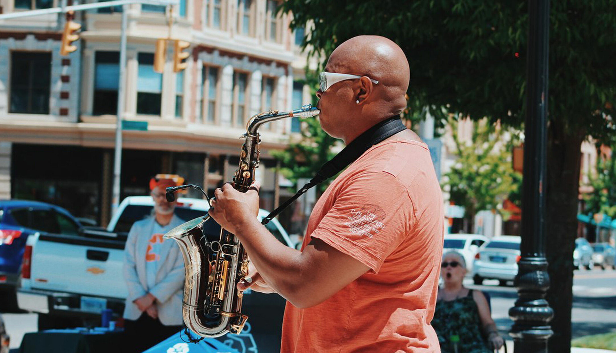 A man playing the saxophone in front of onlookers at Make Music Day in Waterbury CT