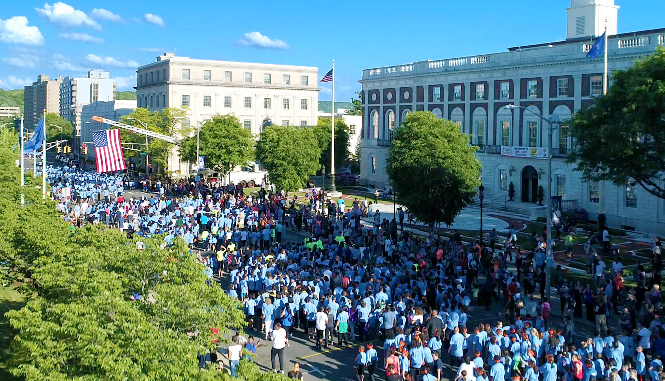 A crowd gathers in the city streets of downtown Waterbury CT to run a marathon 