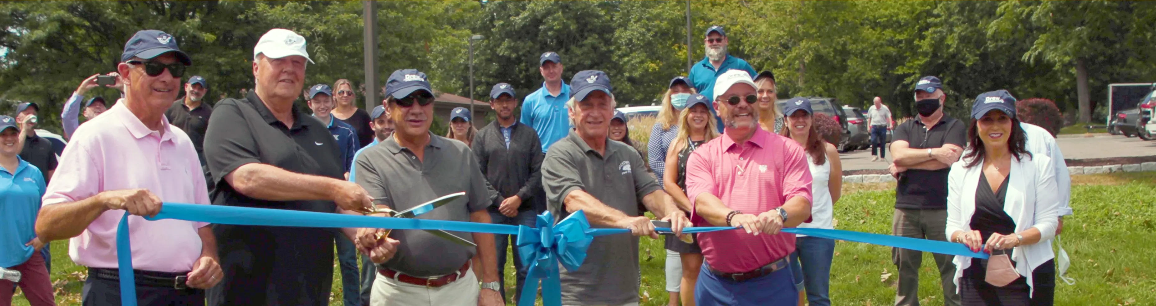Members of Drew International and local leaders at a ribbon cutting ceremony