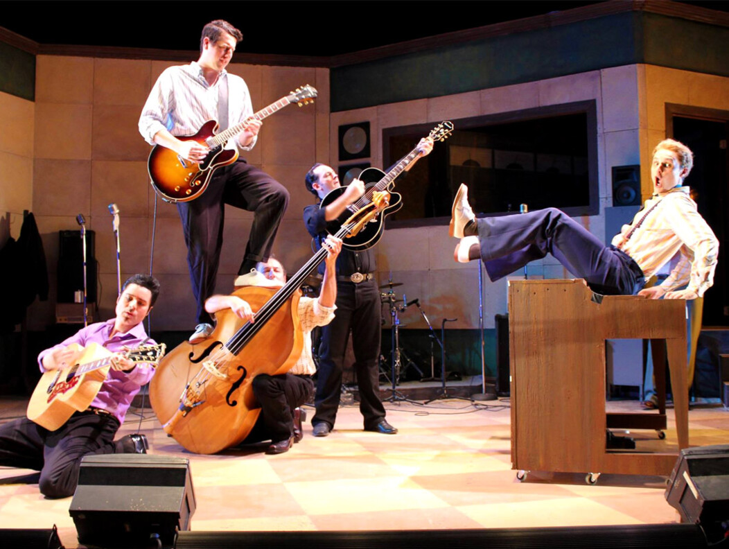 Five performers holding instruments on stage at the Seven Angels Theater in Waterbury CT