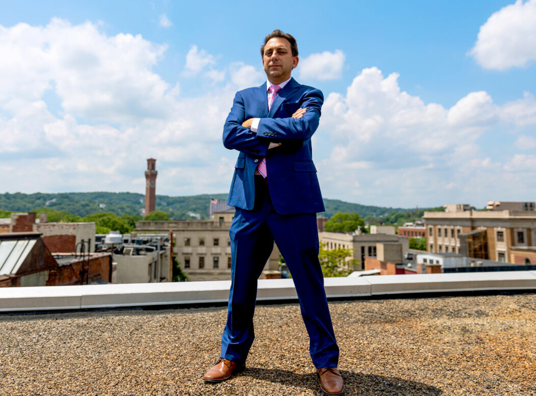 Joe Gramando standing with arms crossed on the rooftop of a Waterbury CT building