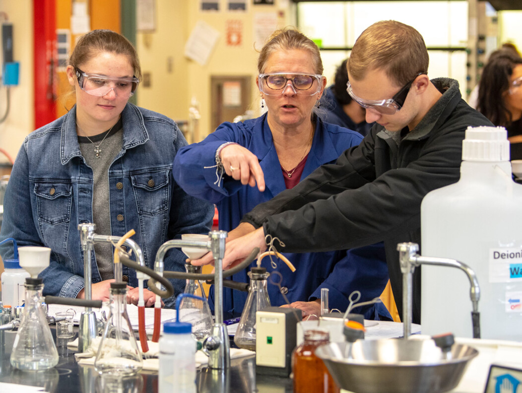 UConn Waterbury students in science lab with teacher working on a lab project