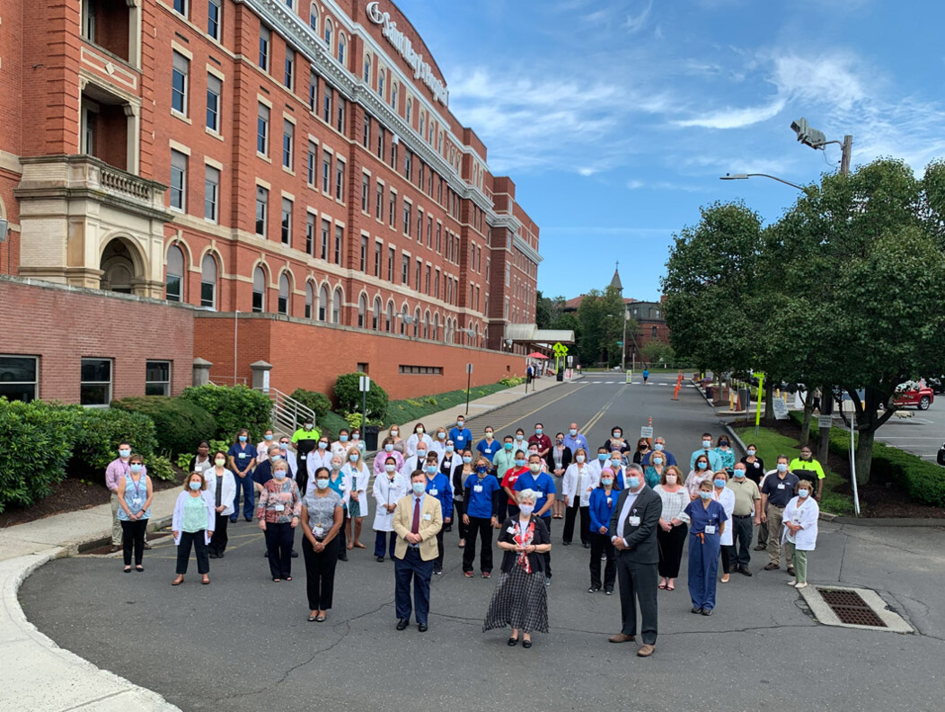 The team from Saint Marys Hospital in Waterbury CT standing in the city streets wearing medical masks