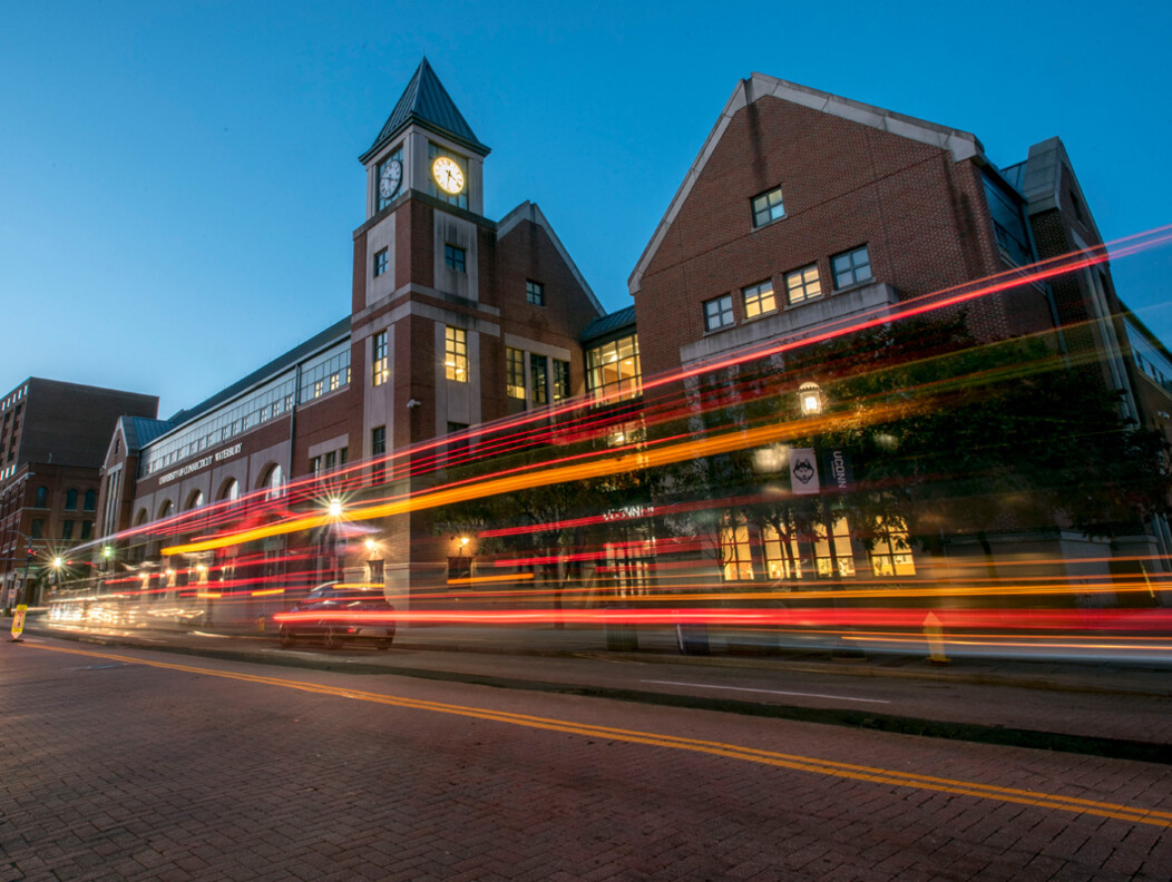 Exterior photo of UConn in Dowtown Waterbury CT in the evening with car lights in motion