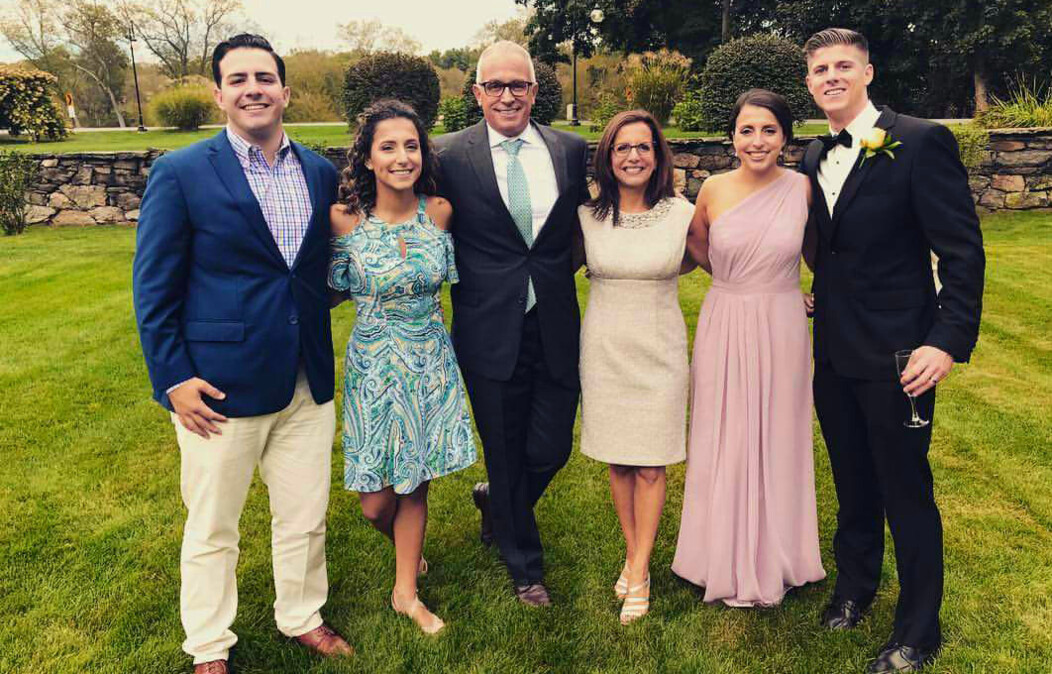 Frank Tavera of Waterbury CT standing and smiling with his wife and children