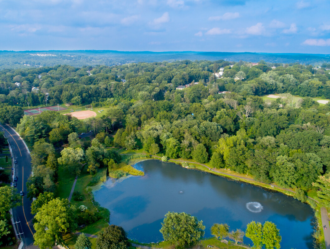 Scenic view of the water feature and trees located in Fulton Park in Waterbury CT